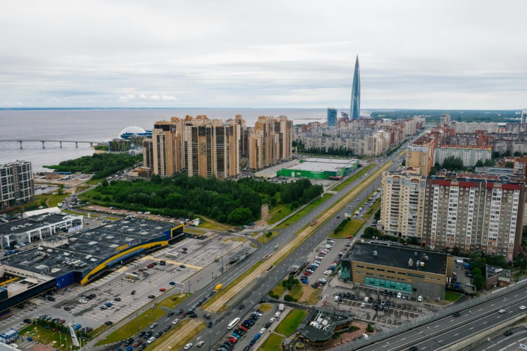 Aerial shot capturing the modern cityscape featuring a distinctive skyscraper and urban infrastructure.